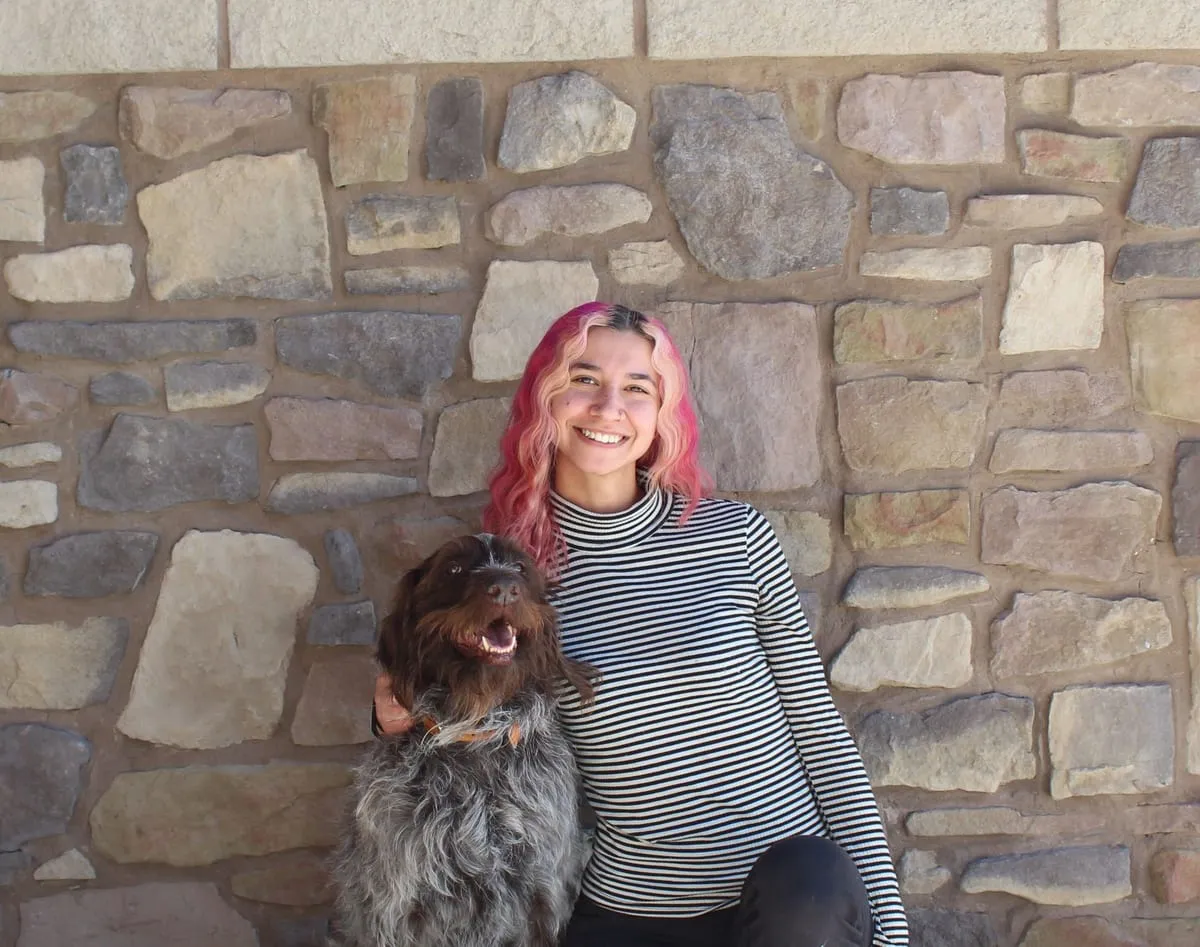 Portrait of Angie, Grooming Assistant & Bather at Farr West Animal Hospital, with a dog