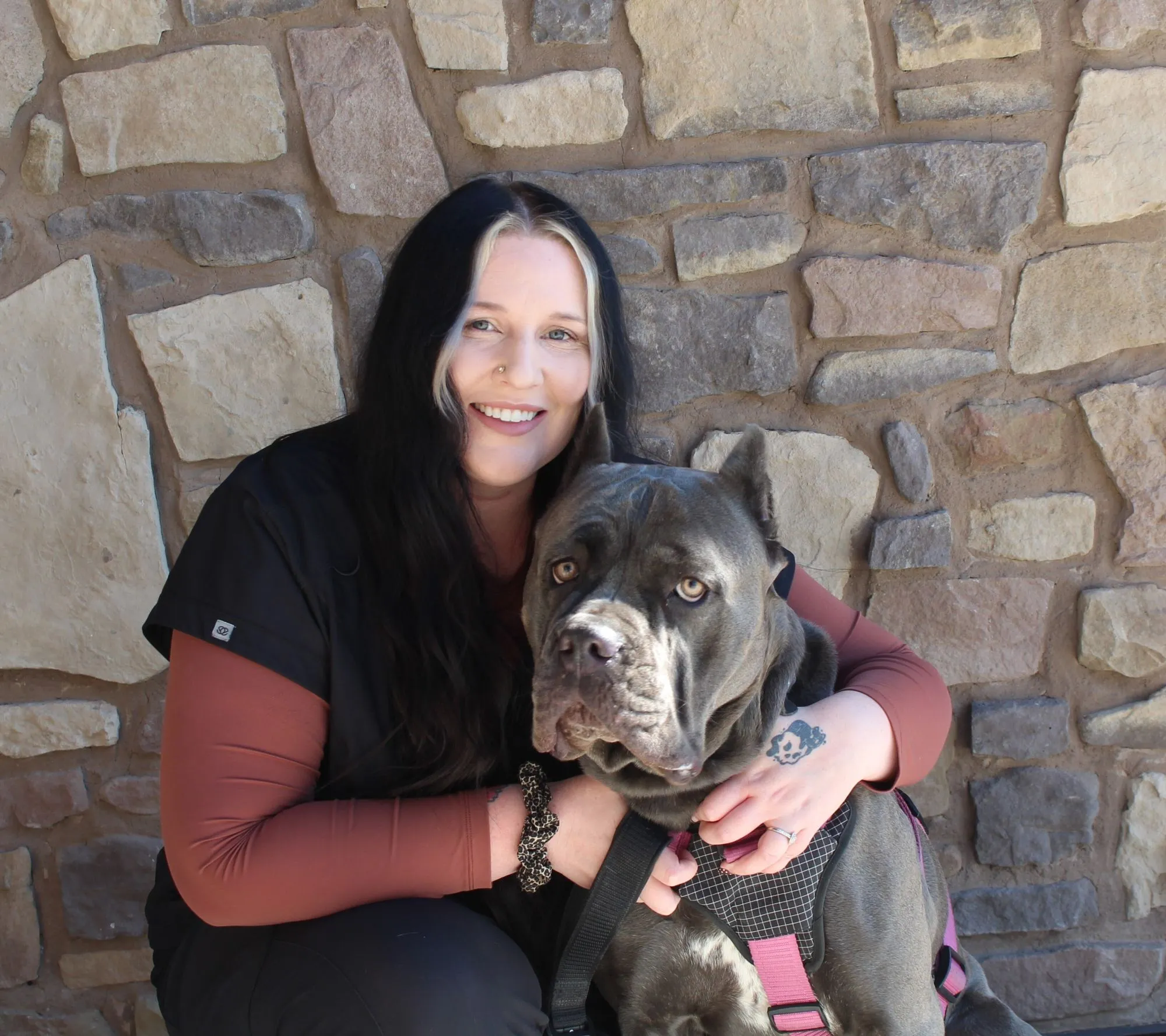Portrait of Danielle, Veterinary Technician at Farr West Animal Hospital, with a Cane Corso